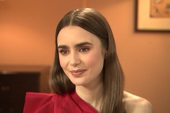 Lily Collins w eleganckiej gali na czerwonym dywanie, ukazująca jej wyczucie stylu i pewność siebie.